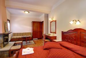 a bedroom with a large bed and a living room at Guesthouse Theareston in Zagora