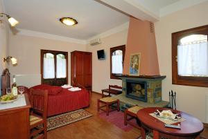 a living room with a bed and a fireplace at Guesthouse Theareston in Zagora