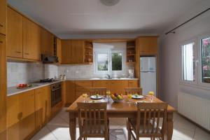 a kitchen with a wooden table and chairs and a table and chairsktop at Casa Di Giovani in Kokkini Khanion