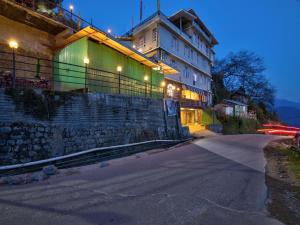 a building with lights on the side of a street at The Griffon's Nest in Gangtok