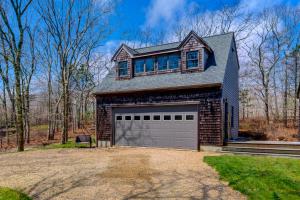 a house with a garage and a house at Treetop in Edgartown