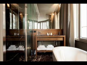 a bathroom with a sink and a mirror and a tub at Triviho Hotel in Rome