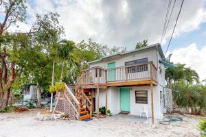 a house on the beach with a deck at Cindy Villa in Key Largo
