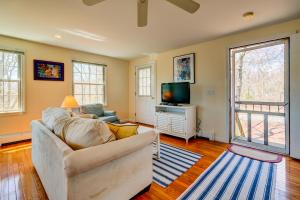 a living room with a couch and a tv at Treetop in Edgartown