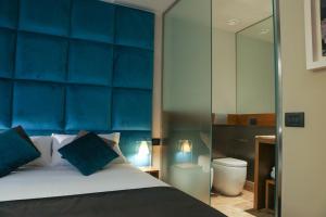 a bed room with a white bedspread and a blue comforter at Triviho Hotel in Rome