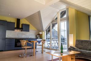 a kitchen and living room with a couch and a table at Ferienwohnungen Scheid Volker in Sankt Aldegund