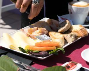 a plate of food with bread and vegetables on a table at The Purple Hotel - Adults Only in San Antonio