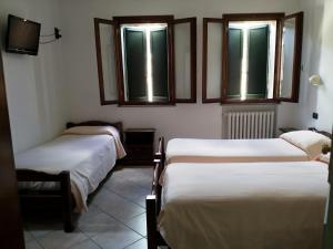 Łóżko lub łóżka w pokoju w obiekcie Acquacheta Valtancoli