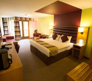 a hotel room with a bed and a living room at The Gulliver's Hotel in Warrington