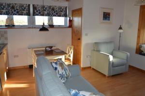 a living room with a couch and a table at Nisbet's Tower in Eyemouth