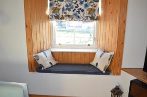 a bench in a window with pillows in a room at Nisbet's Tower in Eyemouth