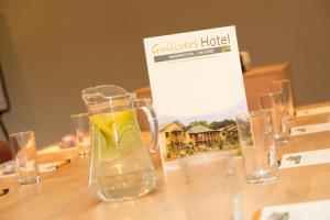 a glass jug of water sitting on a wooden table at The Gulliver's Hotel in Warrington +36 photos