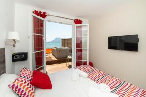 a bedroom with a bed and a view of the ocean at Hôtel George Sand in La Seyne-sur-Mer