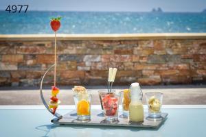 a tray with fruit and drinks on a table at Hôtel George Sand in La Seyne-sur-Mer