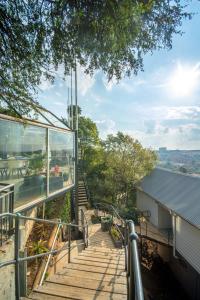 a staircase leading up to a house with glass walls at Pablo House in Johannesburg