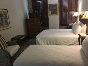 Pokój hotelowy z 2 łóżkami i krzesłem w obiekcie Park Plaza Hotel Orlando - Winter Park w Orlando