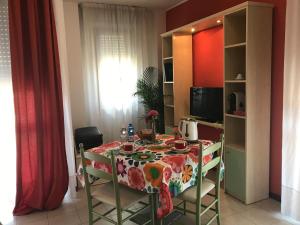 a kitchen with a table, chairs and a refrigerator at Residence Viale Venezia in Verona