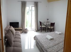 a living room with a couch and a table at Apartments AS in Budva