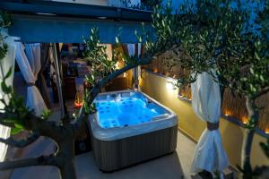 a jacuzzi tub in a room with a tree at Pool Apartments Julia in Zadar