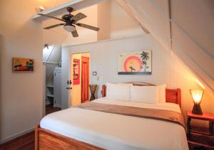 a bedroom with a bed and a ceiling fan at Casa Cecilia Beach Front in Santa Teresa Beach