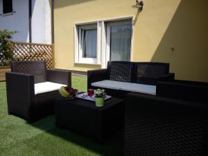 a patio with two chairs and a table with a plate of food at I Colli del Garda in Lonato