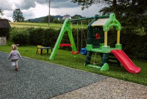 a little girl is playing on a playground at Agronoclegi ,,Na Równi" 535-950-405 in Mchawa