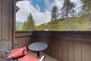 a patio with a table and a chair on a balcony at Timber Creek in Copper Mountain