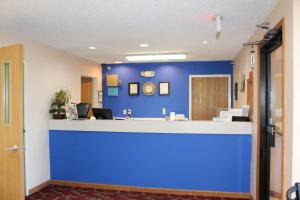 a lobby with a blue wall in a hospital at Super 8 by Wyndham Chenoa in Chenoa