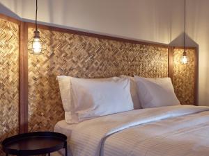 a bedroom with a bed with two lights on it at Cavo Vezal in Laganas
