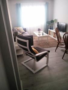 a living room with a chair and a couch at San Lorenzo House in Gijón