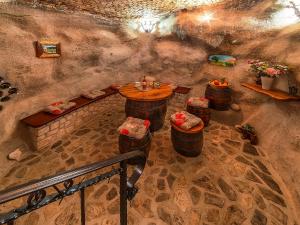a room with a table and barrels in a cave at Apartments Roža in Roč