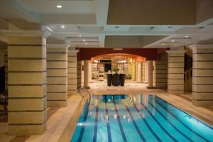 a swimming pool in a building with columns at Majorica Marina Hotel in El Alamein