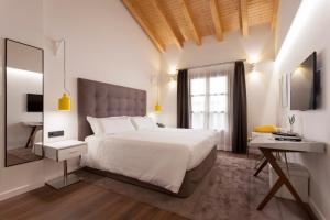 
a hotel room with a large bed and a large window at Hotel Bosch Boutique in Palma de Mallorca
