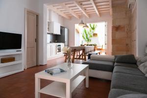 a living room with a couch and a table at Cal Bisbe in Ciutadella