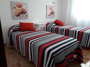 two beds sitting next to each other in a room at Casa Olivina 2 in Puerto del Carmen