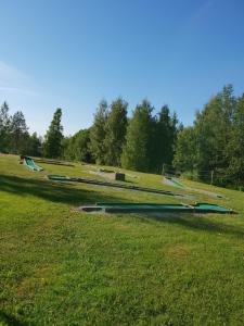 a grassy field with trees and grass covered lawns at Savonlinna Camping Vuohimäki in Savonlinna