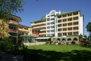 a large building with a lawn in front of it at Parkhotel in Bad Füssing