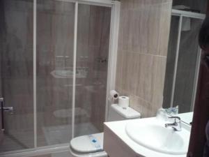 a bathroom with a shower and a toilet and a sink at Valcarce Urbasa in Olazagutía