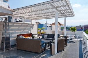 a patio with furniture and a fireplace on a roof at Lombardo Suites in Mexico City