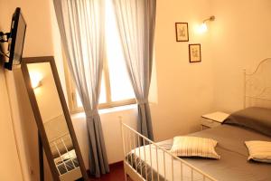 a small bedroom with a bed and a window at Apartment - Laterano 85 in Rome