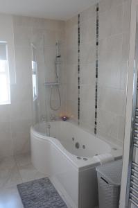 a white bath tub in a bathroom with a shower at Avondale Farmhouse B&B in Pettigoe