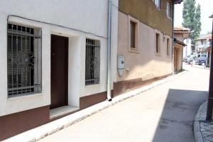 an empty street next to a building with a door at Epicentar in Sarajevo