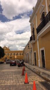 a street with orange cones in front of a building at Hotel San Miguel Arcangel in Izamal