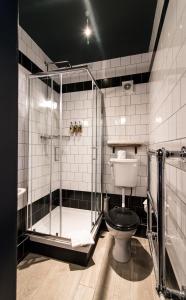 a bathroom with a glass shower and a toilet at The Waterman in Cambridge