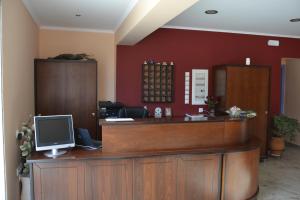 a reception desk with a computer on top of it at Kalias Hotel in Vasiliki +37 photos