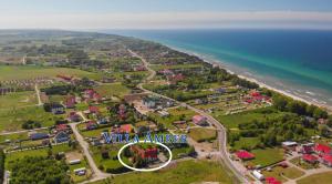 an aerial view of a village next to the ocean at Villa Amber in Sarbinowo
