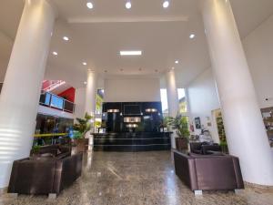 a lobby of a building with columns and chairs at Marruá Hotel in Bonito +37 photos
