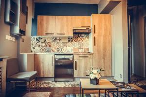 a kitchen with wooden cabinets and a table in a room at Oasis Anjou in Saumur