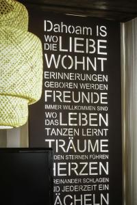 a wall with a sign that reads dahlwegian is the leaguexualxual feminism at Ferienwohnung Moarhofer in Muhr