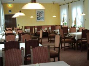 a dining room with tables and chairs and tablesktop at Hotel an der Ilse in Lemgo